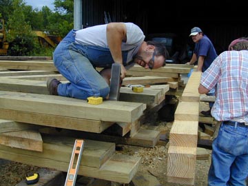 Albert Lauzon, Roland Blais, and Nathan Cote have completed construction of the trusses and are fitting the end-posts.